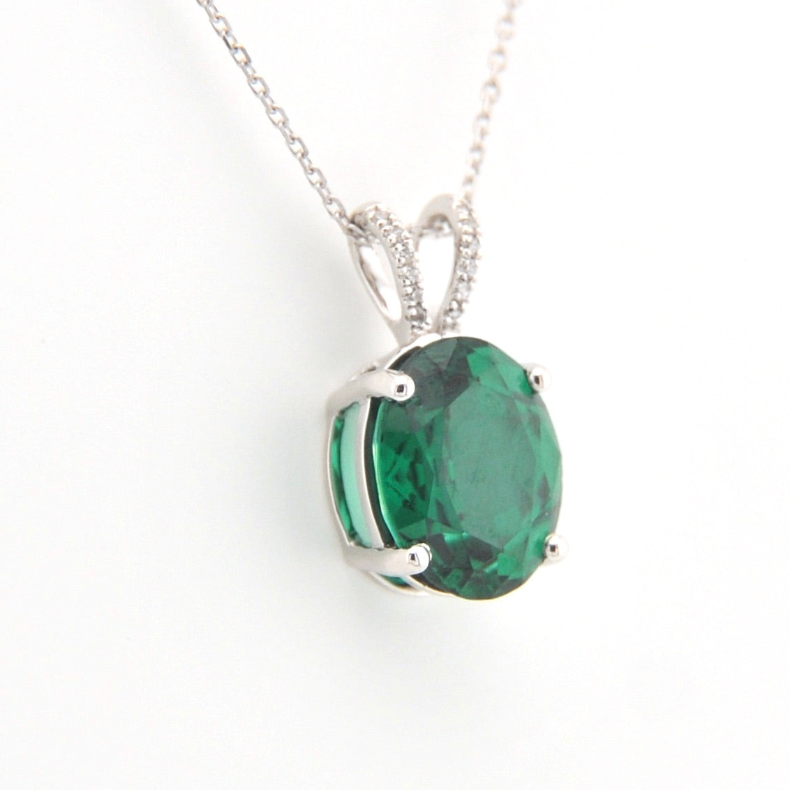 Green gemstone pendant on a white background