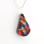 Teardrop-shaped pendant with multicolored pattern on a white background