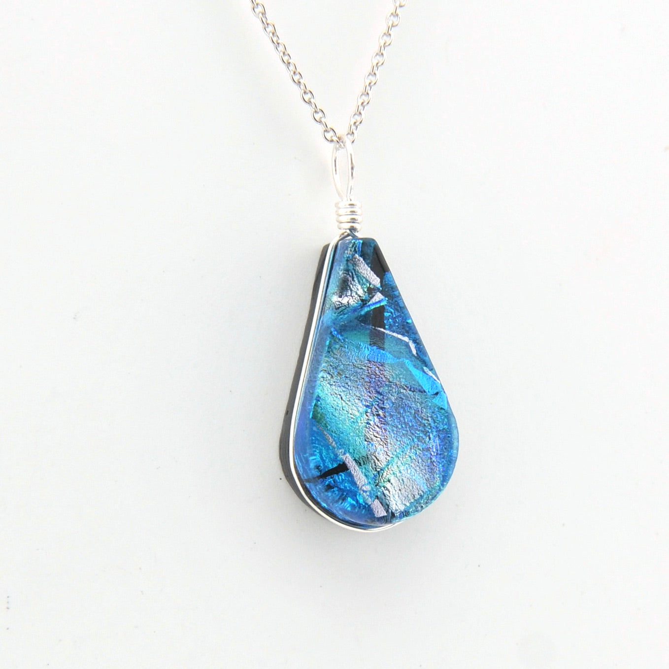 Blue teardrop pendant on a white background