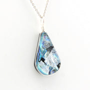 Teardrop-shaped pendant with a blue and silver design on a white background