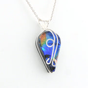 Teardrop-shaped pendant with colorful design on a white background