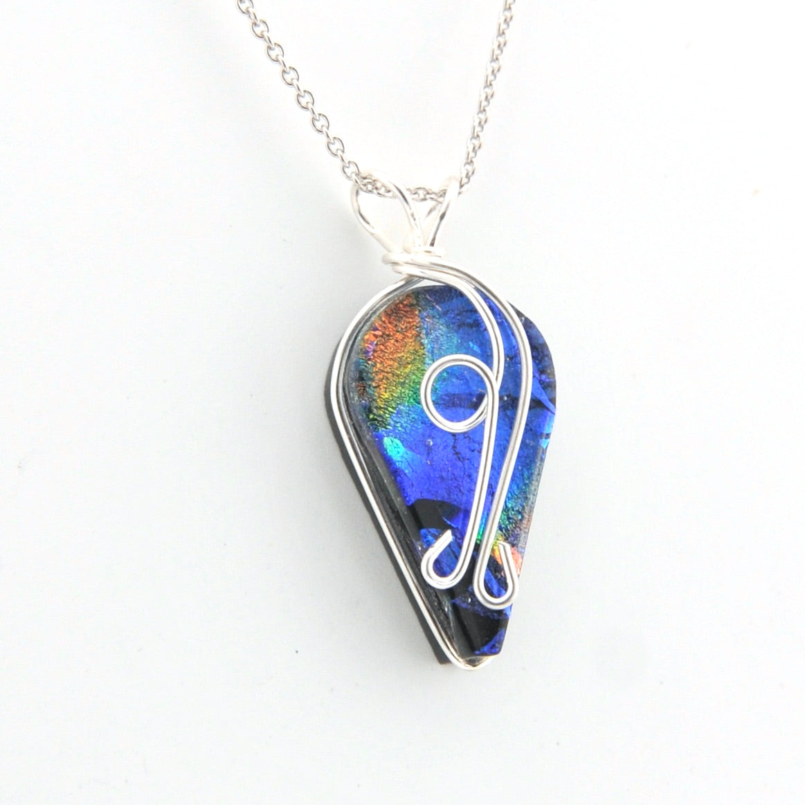 Teardrop-shaped pendant with colorful design on a white background