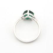 Silver ring with a green gemstone on a white background