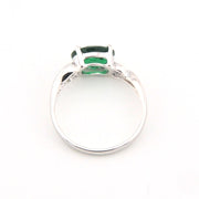 Silver ring with a green gemstone on a white background