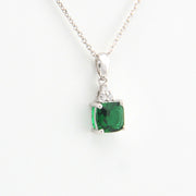 Green gemstone pendant on a white background
