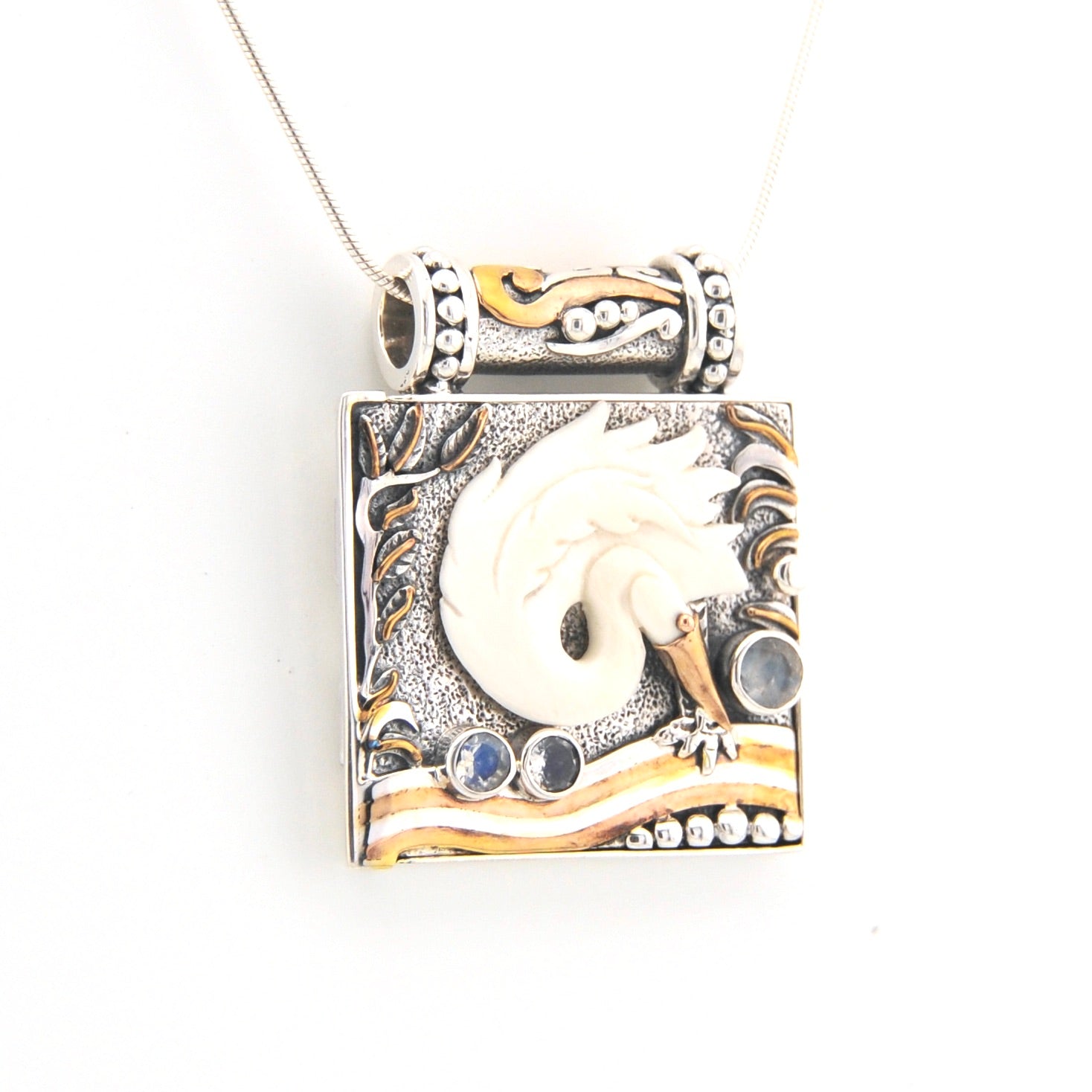 Decorative pendant with intricate designs on a white background
