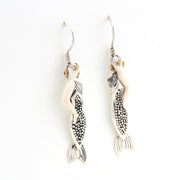 Silver mermaid earrings on a white background