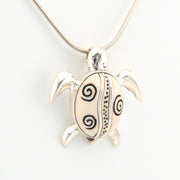 Silver turtle pendant necklace on a white background