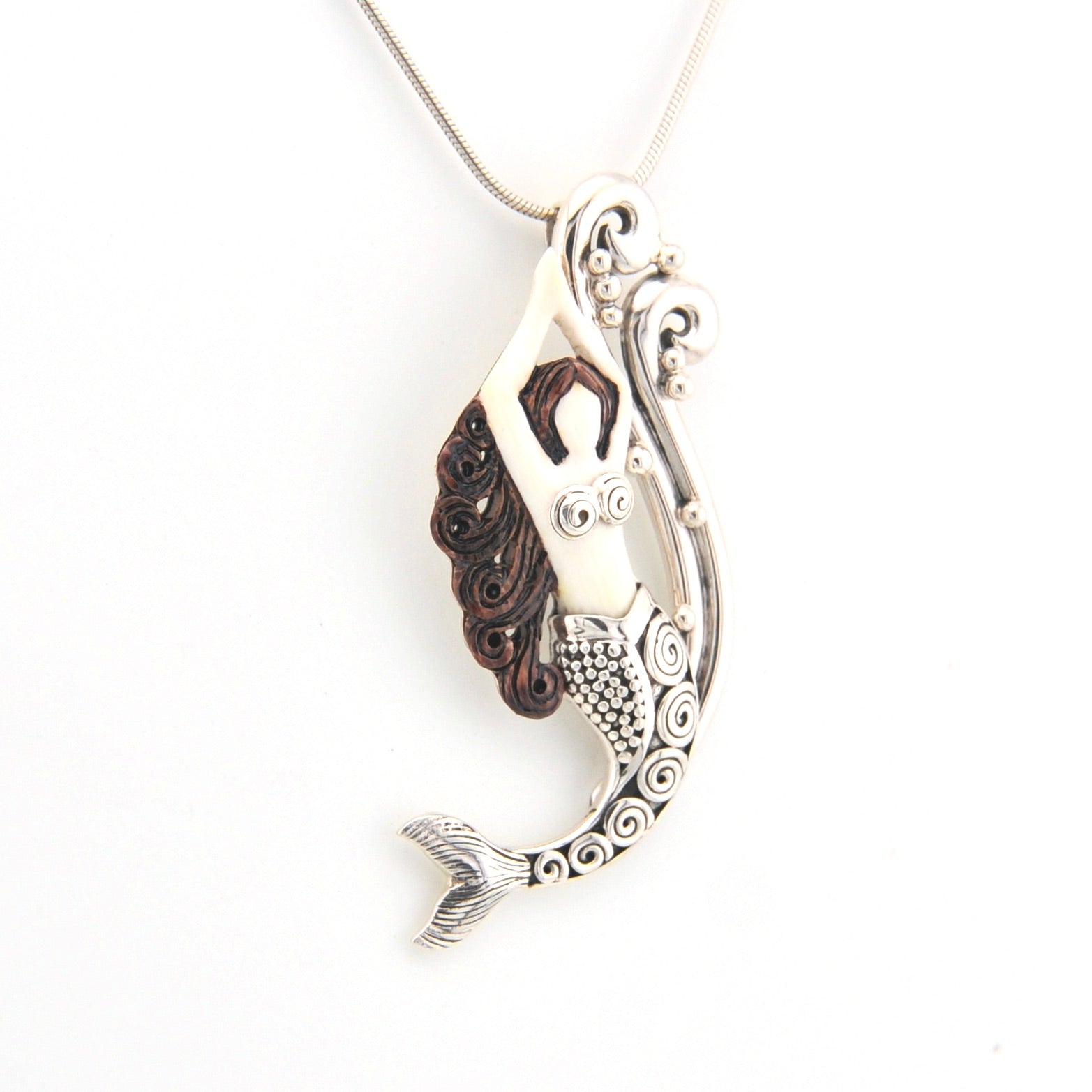 Mermaid tail pendant on a white background
