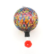Colorful glass sphere with a red flower on a white background