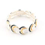 Bracelet with black, gold, and white circular patterns on a white background