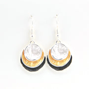 Pair of earrings with gold, black, and clear stone design on a white background