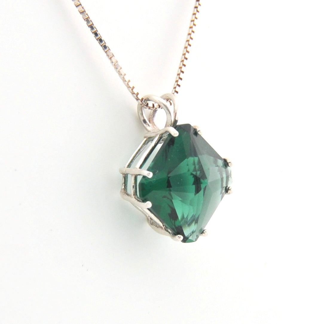 Green gemstone necklace on a white background