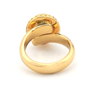 Gold ring with a textured design on a white background