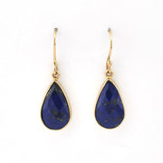 Teardrop-shaped blue stone earrings with gold hooks on a white background