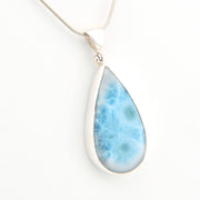Teardrop-shaped larimar pendant on a white background