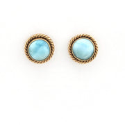 Pair of earrings with gold rims and light blue gemstones on a white background