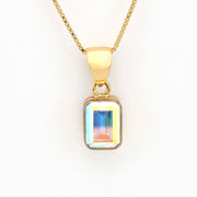 Gold necklace with a rectangular pendant on a white background