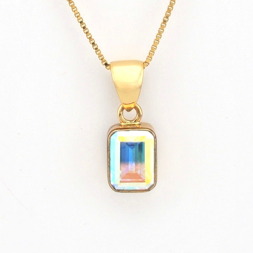 Gold necklace with a rectangular pendant on a white background