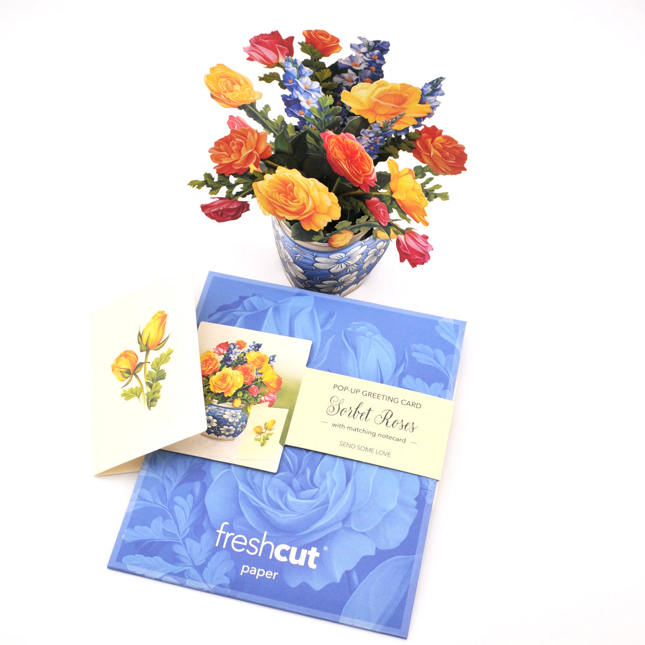 Bouquet of flowers with a matching greeting card and envelope on a white background