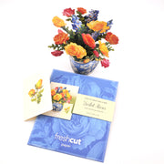 Bouquet of flowers with a matching greeting card and envelope on a white background