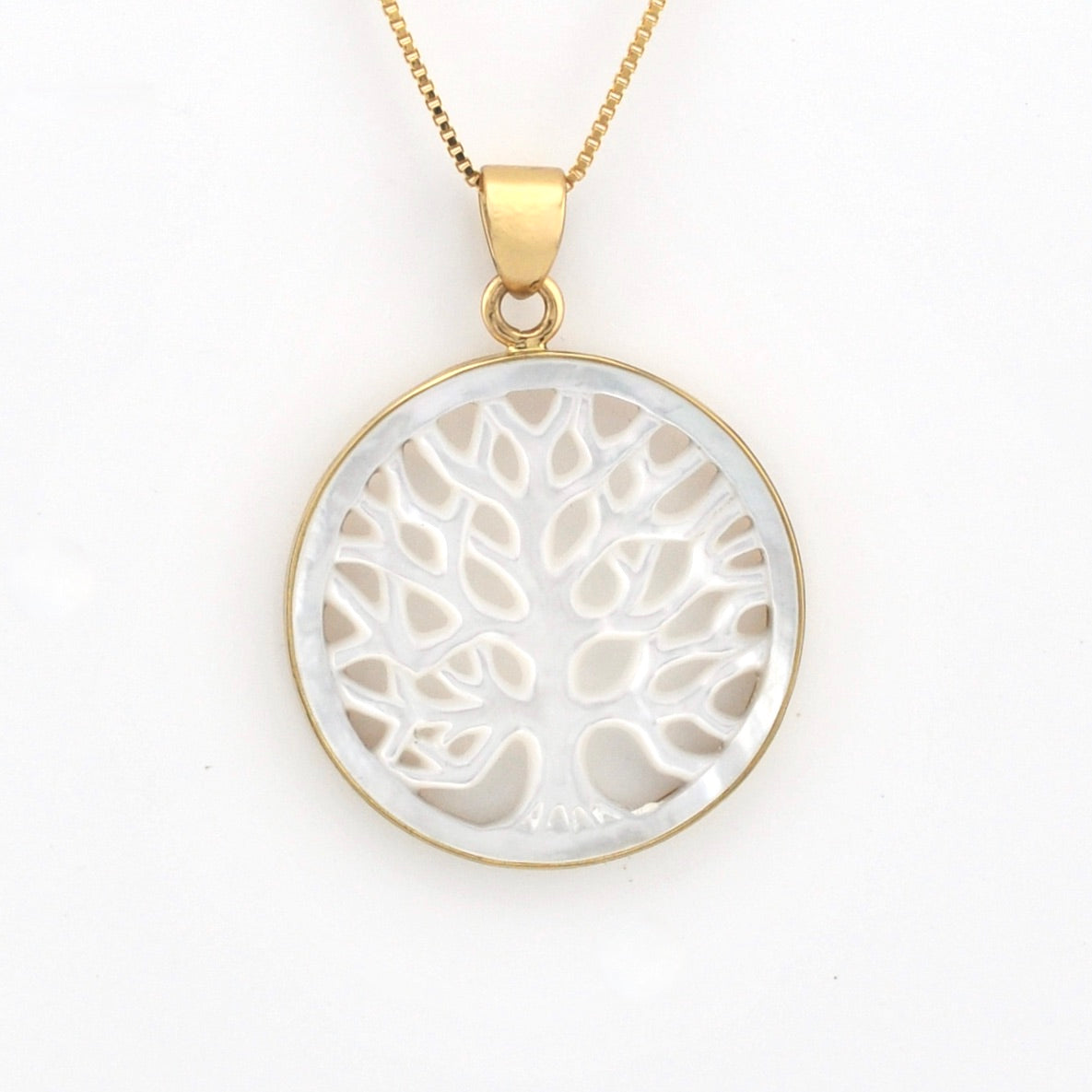 Gold necklace with a white tree-of-life pendant on a white background