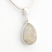Teardrop-shaped silver pendant on a white background