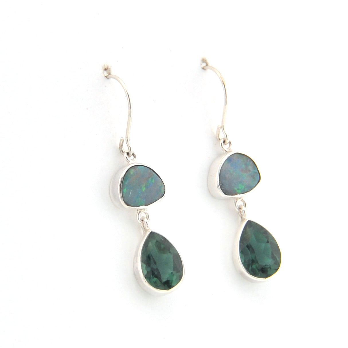 Pair of silver earrings with green gemstones on a white background