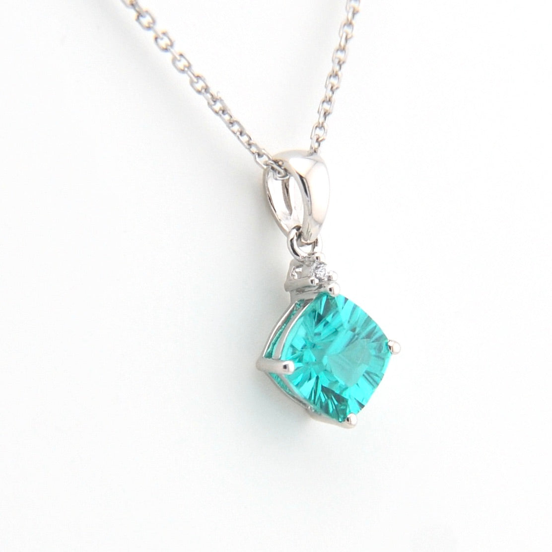 Teal gemstone pendant on a white background
