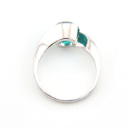 Silver ring with a green gemstone on a white background