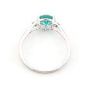 Silver ring with a green gemstone on a white background