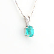 Teal pendant necklace on a white background