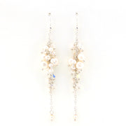 Pair of pearl and crystal earrings on a white background
