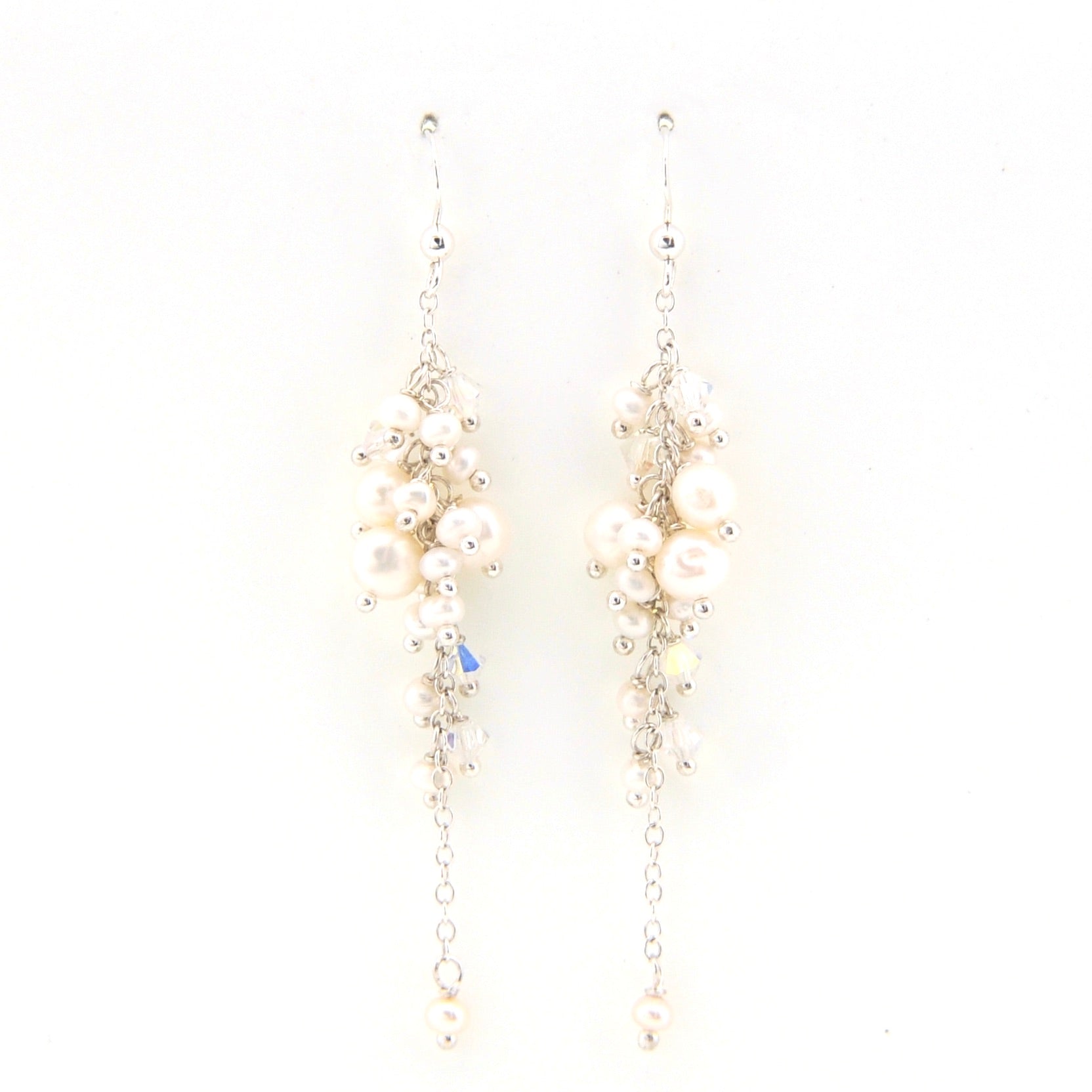 Pair of pearl and crystal earrings on a white background