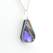 Teardrop-shaped pendant with multicolor pattern on a white background