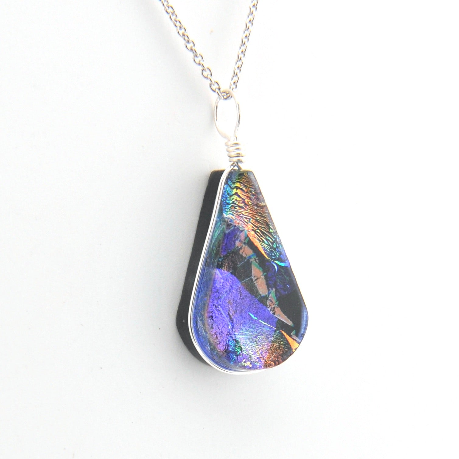 Teardrop-shaped pendant with multicolor pattern on a white background
