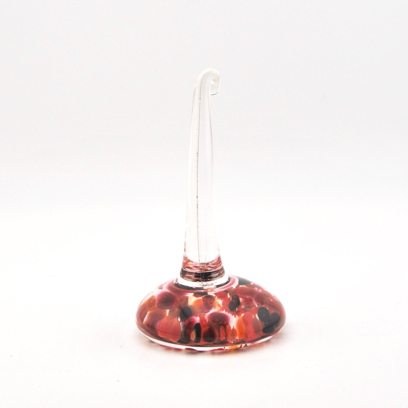 Decorative ring holder with a red and brown pattern on a white background