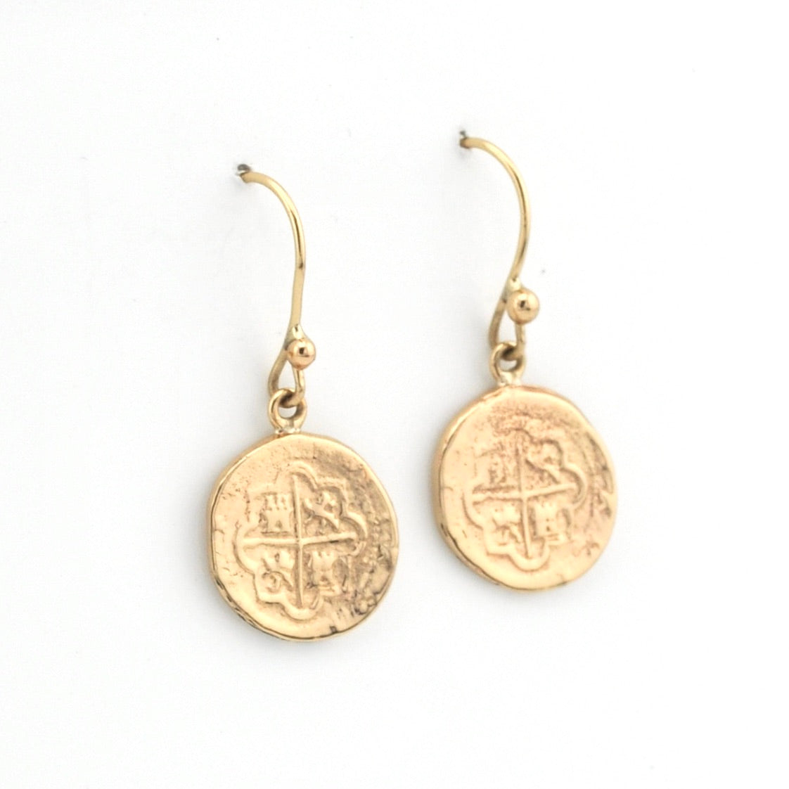 Gold coin-shaped earrings on a white background