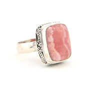 Silver ring with a pink stone on a white background