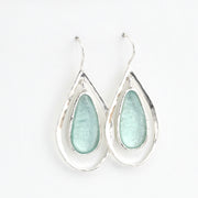 Teardrop-shaped earrings with light blue glass on a white background