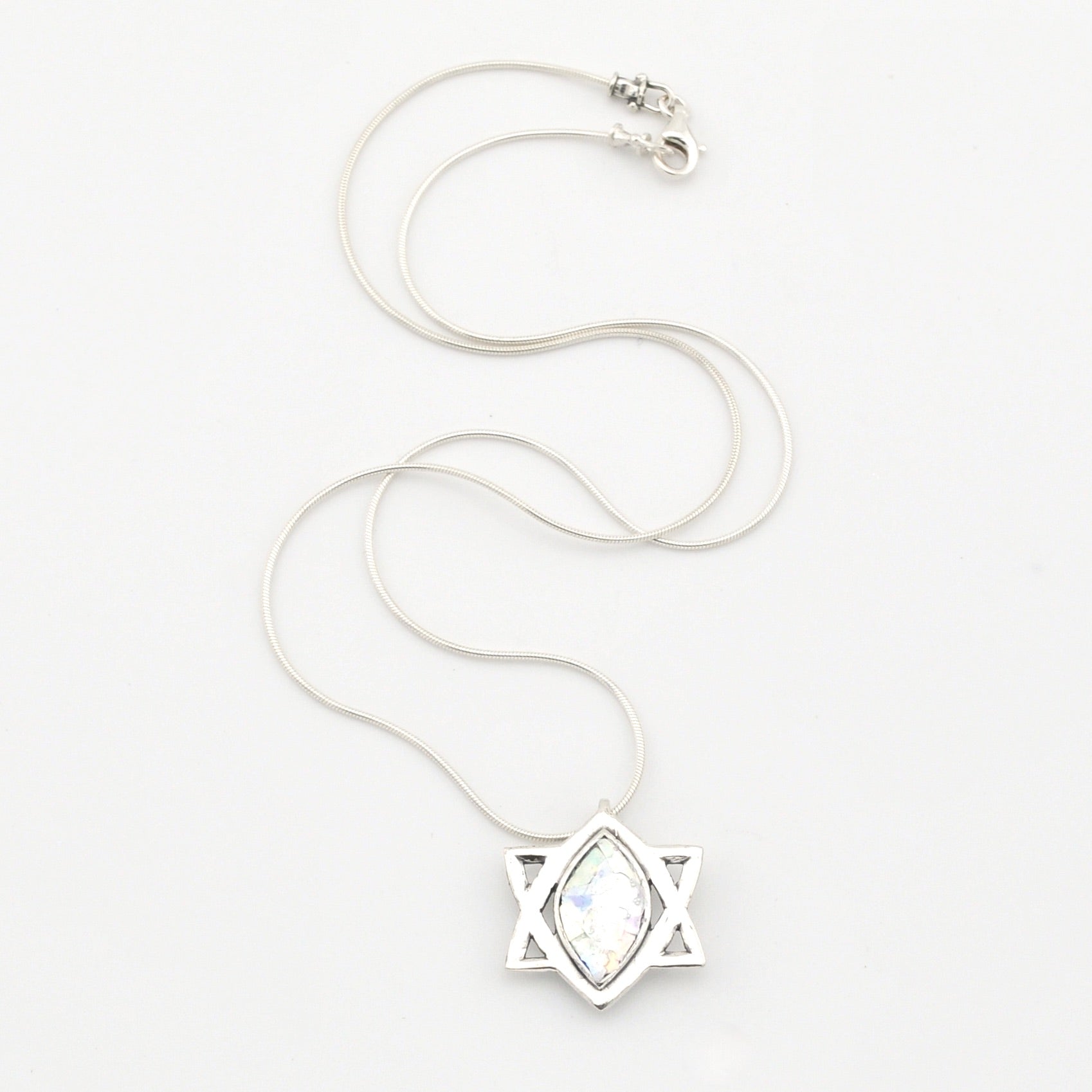 Silver necklace with a star-shaped pendant on a white background