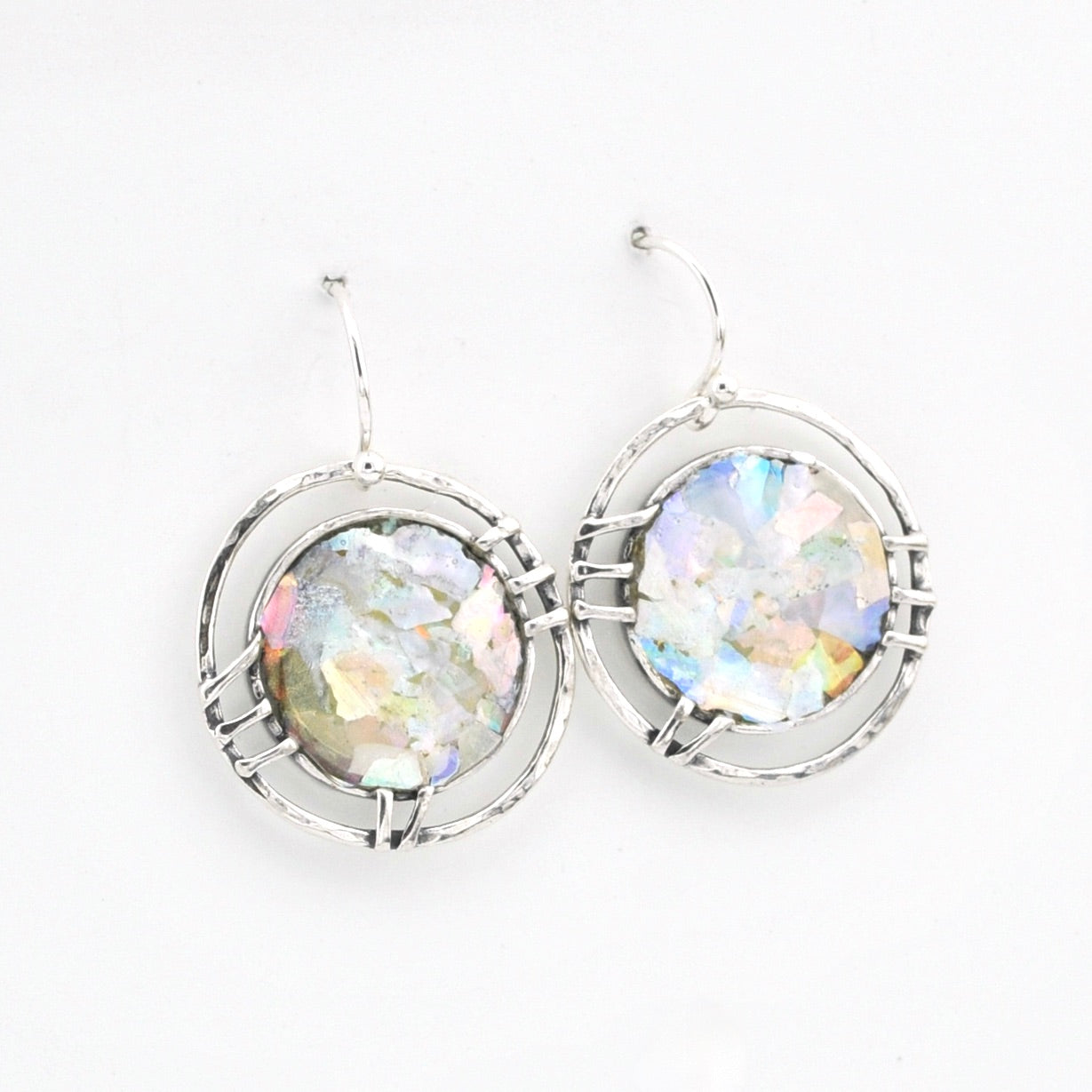 Silver earrings with multicolored glass on a white background