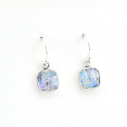 Pair of silver earrings with blue glass on a white background