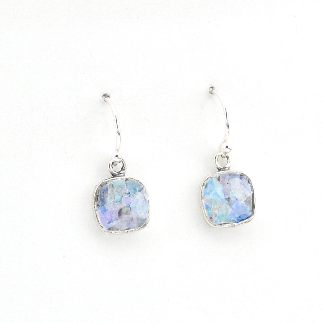 Pair of silver earrings with blue glass on a white background