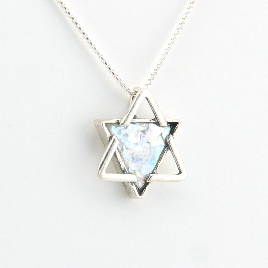 Star-shaped pendant necklace with a light blue stone on a white background