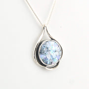 Silver pendant with a blue gemstone on a white background