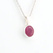 Necklace with a pink gemstone pendant on a white background