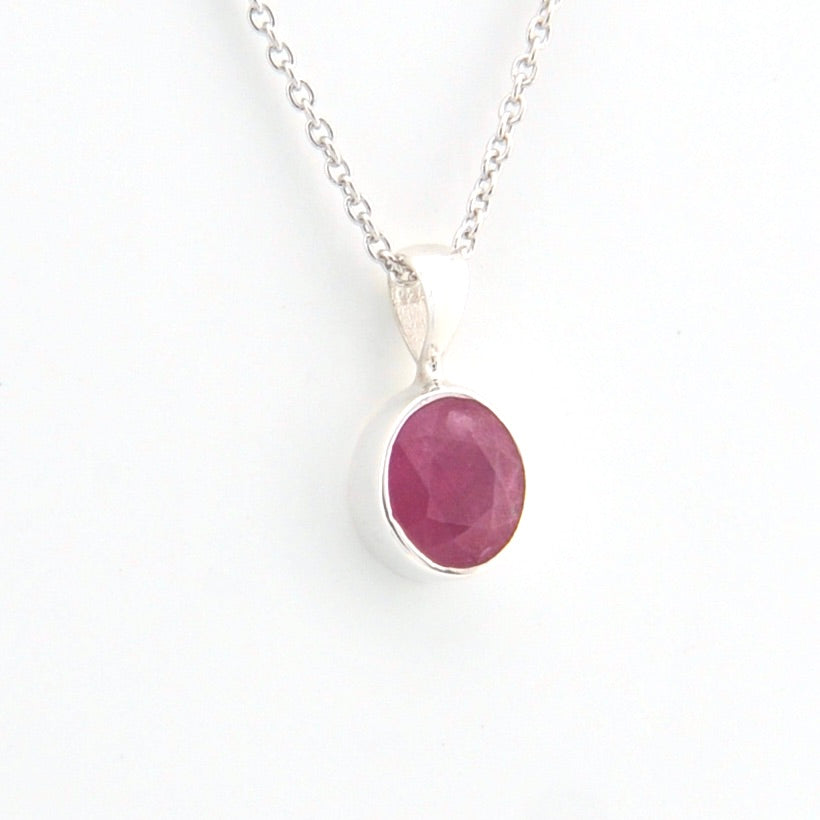 Necklace with a pink gemstone pendant on a white background