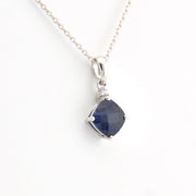 Necklace with a blue gemstone pendant on a white background