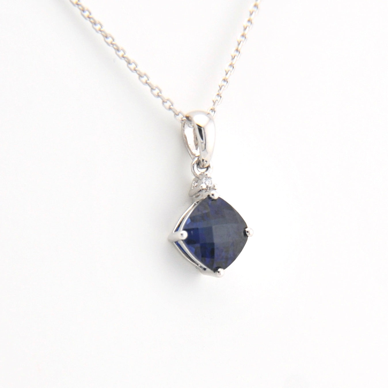 Necklace with a blue gemstone pendant on a white background